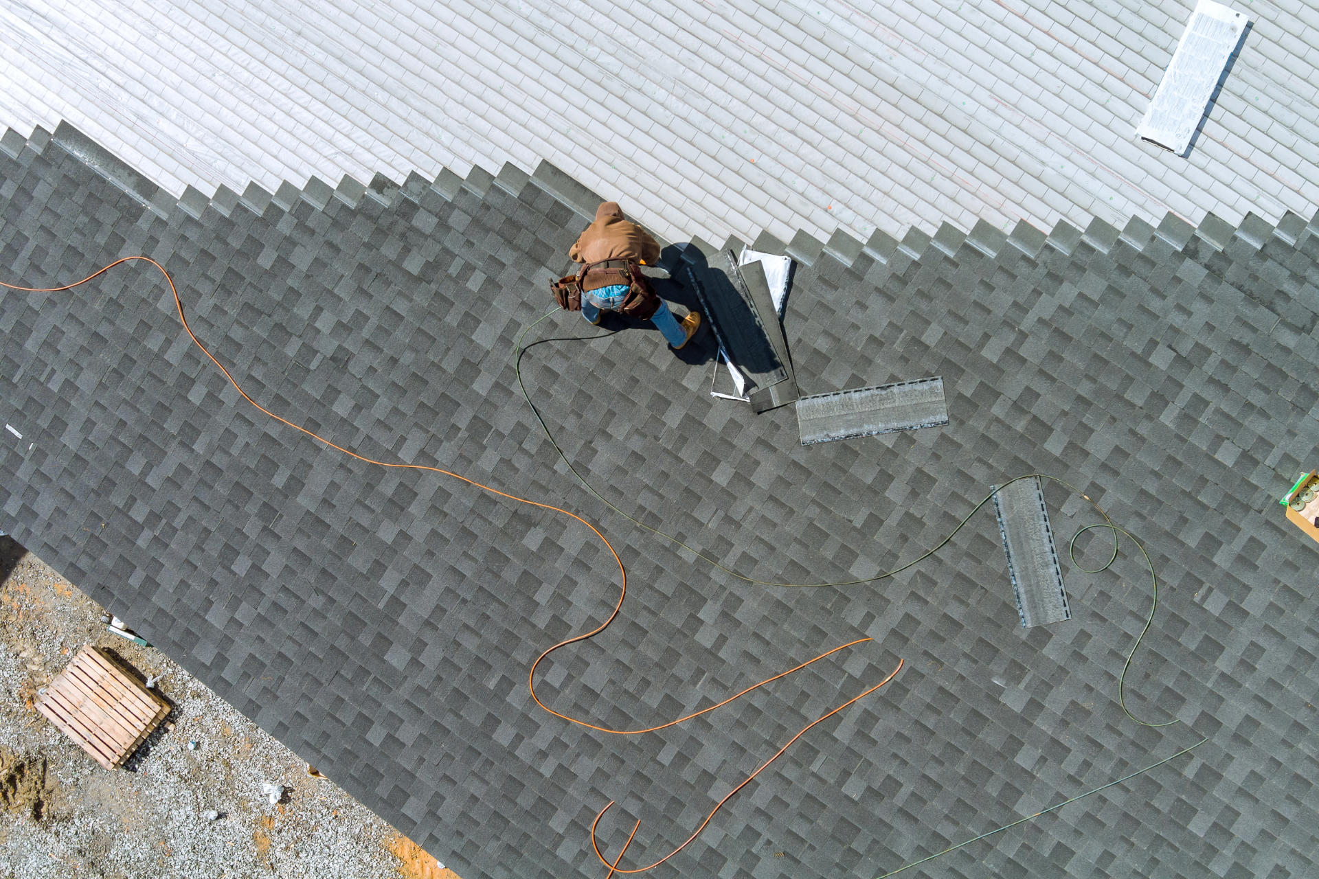 Roofer checking asphalt shingles before winter in Bucks County, PA — Reliable Renovations & Remodeling